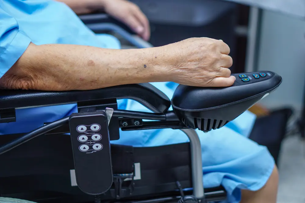 Close view of the joystick and controls of a powered mobility chair