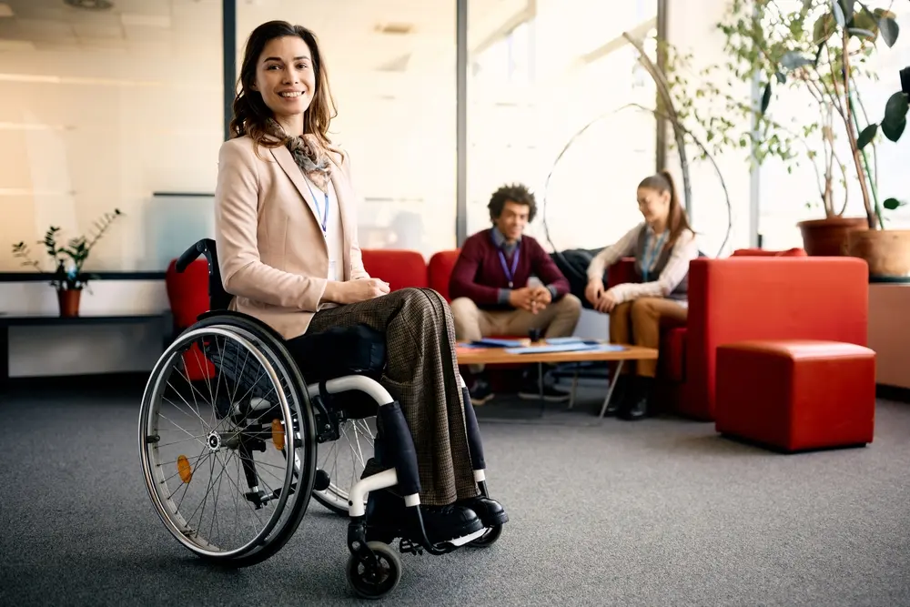 Wheelchair user talking with two other people at a table